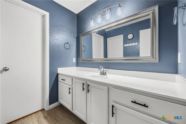 3410 Regency Ct, Killeen, TX 76549 - bathroom with wood finished floors, vanity, and a textured wall