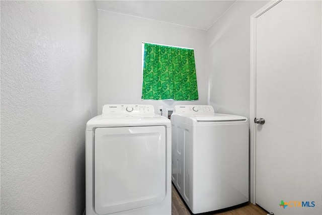 3410 Regency Ct, Killeen, TX 76549 - washroom with washer and clothes dryer and wood finished floors