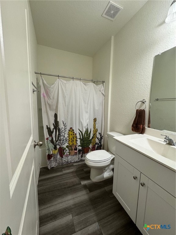 bathroom featuring hardwood / wood-style flooring, vanity, and toilet