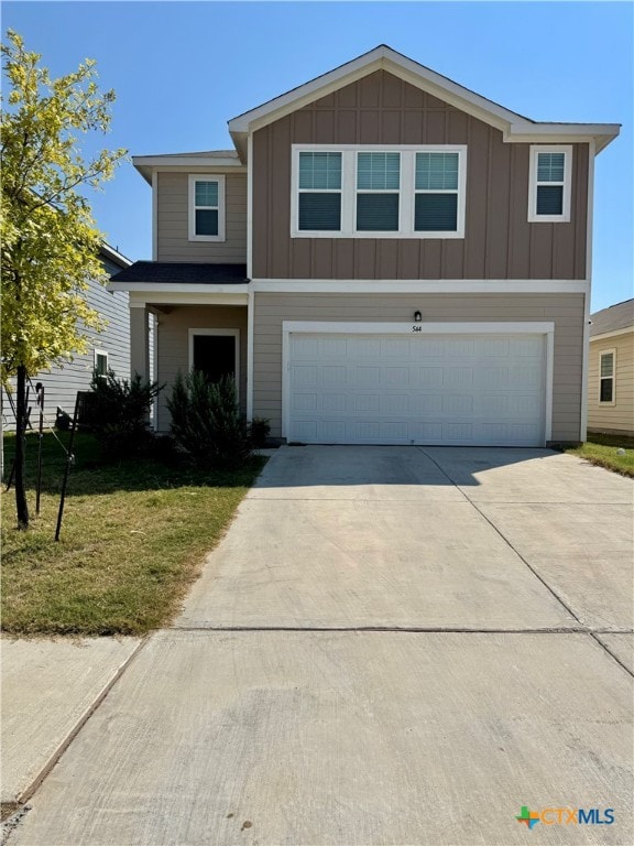 view of front facade with a garage and a front lawn