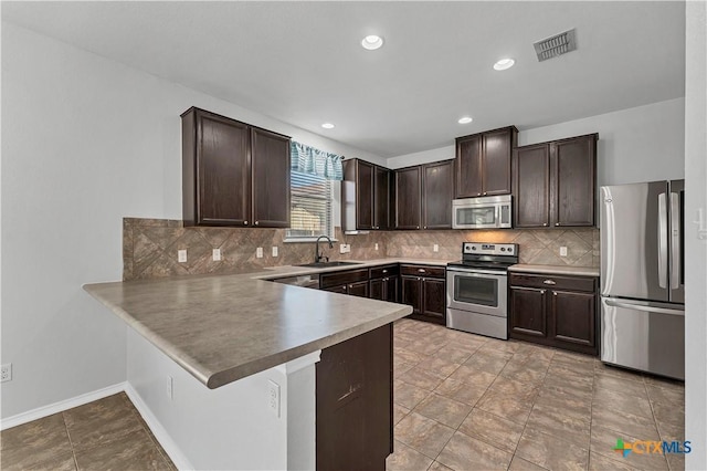 111 Sheep Trail Dr, Kyle, TX 78640 - kitchen with dark brown cabinetry, a sink, stainless steel appliances, and visible vents