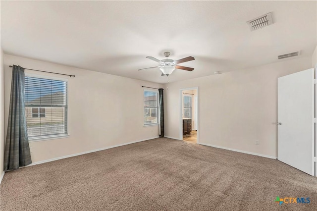 111 Sheep Trail Dr, Kyle, TX 78640 - empty room with baseboards, visible vents, a ceiling fan, and light carpet