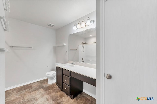 111 Sheep Trail Dr, Kyle, TX 78640 - full bathroom with stone finish floor, toilet, vanity, visible vents, and a shower