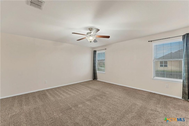 111 Sheep Trail Dr, Kyle, TX 78640 - spare room featuring carpet, visible vents, a wealth of natural light, and a ceiling fan