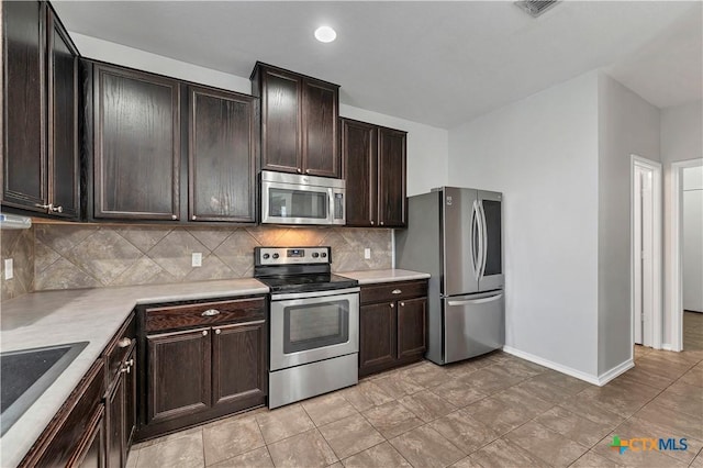 111 Sheep Trail Dr, Kyle, TX 78640 - kitchen featuring tasteful backsplash, appliances with stainless steel finishes, light countertops, dark brown cabinets, and baseboards