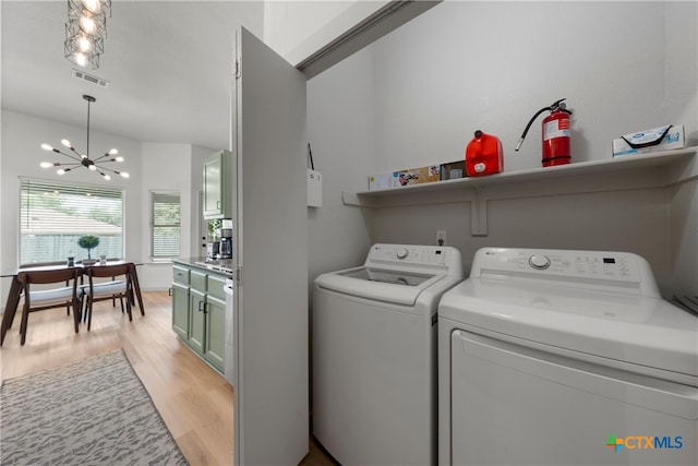 4810 Stone Pointe Dr, Temple, TX 76502 - laundry room featuring a chandelier, light wood-type flooring, and separate washer and dryer