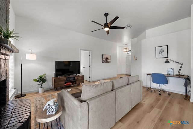 4810 Stone Pointe Dr, Temple, TX 76502 - living area with a ceiling fan, light wood-style floors, a brick fireplace, and an office area