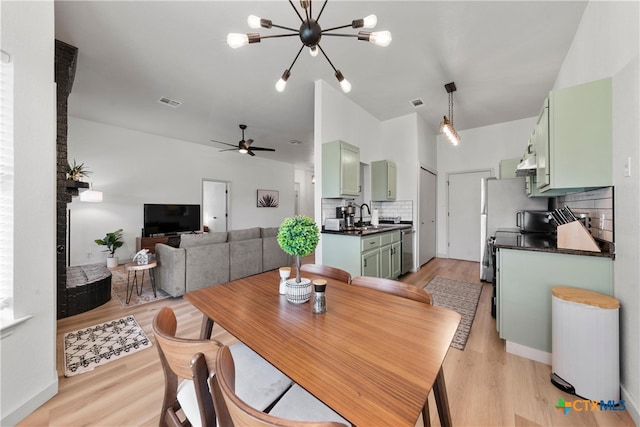 4810 Stone Pointe Dr, Temple, TX 76502 - dining space with a chandelier, ceiling fan, and light wood finished floors