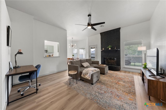 4810 Stone Pointe Dr, Temple, TX 76502 - living area with wood finished floors, plenty of natural light, ceiling fan, and a chandelier