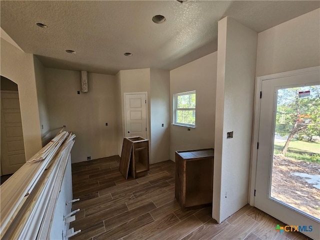 1645 Pecan Cir, Canyon Lake, TX 78133 - kitchen with wood tiled floors, a textured ceiling, recessed lighting, and arched walkways