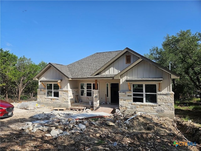 1645 Pecan Cir, Canyon Lake, TX 78133 - view of front of home featuring a shingled roof, stone siding, board and batten siding, and a patio area