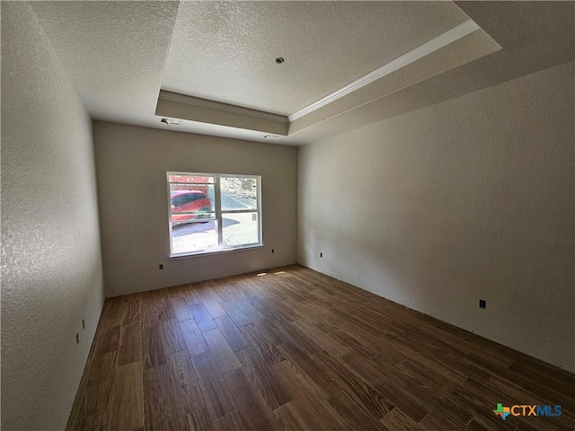 1645 Pecan Cir, Canyon Lake, TX 78133 - unfurnished room featuring a tray ceiling, wood finished floors, a textured wall, a textured ceiling, and crown molding