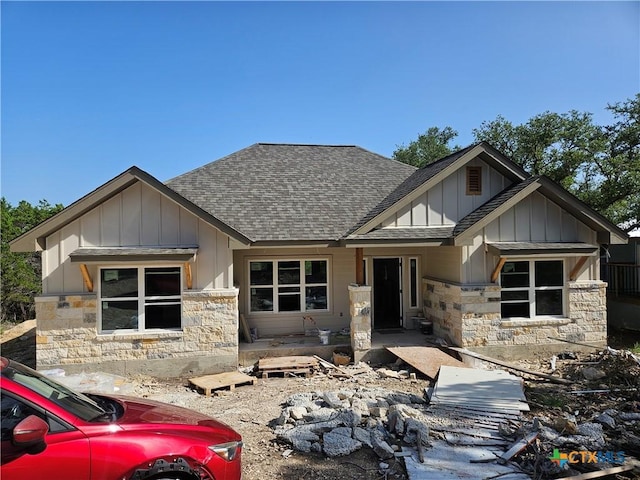 1645 Pecan Cir, Canyon Lake, TX 78133 - view of front of house with a shingled roof, board and batten siding, and stone siding
