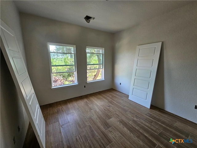 1645 Pecan Cir, Canyon Lake, TX 78133 - spare room featuring dark wood finished floors and a textured wall