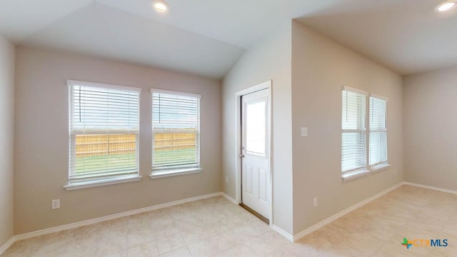 entrance foyer featuring vaulted ceiling