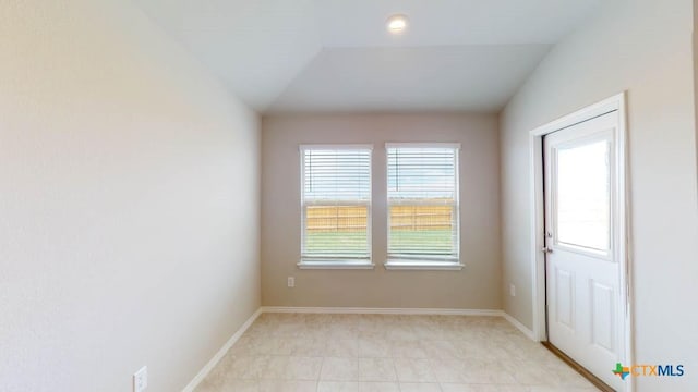 spare room with vaulted ceiling