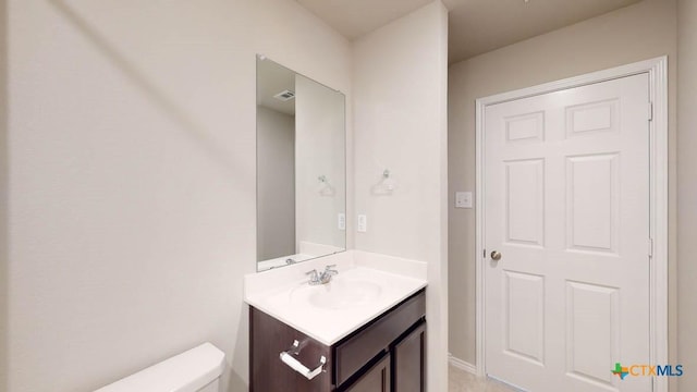 bathroom with vanity and toilet