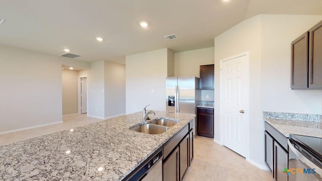 kitchen featuring dark brown cabinetry, sink, light stone countertops, and stainless steel appliances