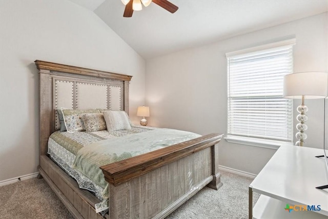 bedroom featuring a ceiling fan, lofted ceiling, light colored carpet, and baseboards