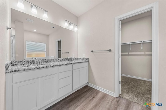 bathroom with vanity and wood-type flooring