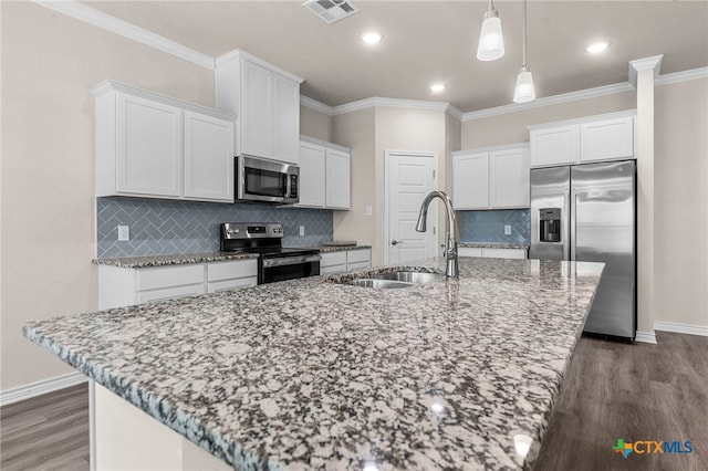 kitchen featuring a kitchen island with sink, white cabinetry, sink, and stainless steel appliances