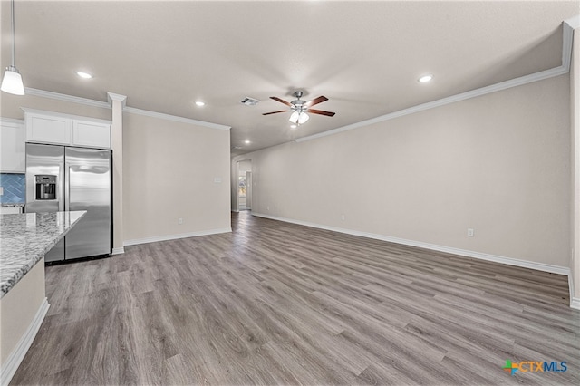 unfurnished living room featuring light hardwood / wood-style flooring, ceiling fan, and crown molding