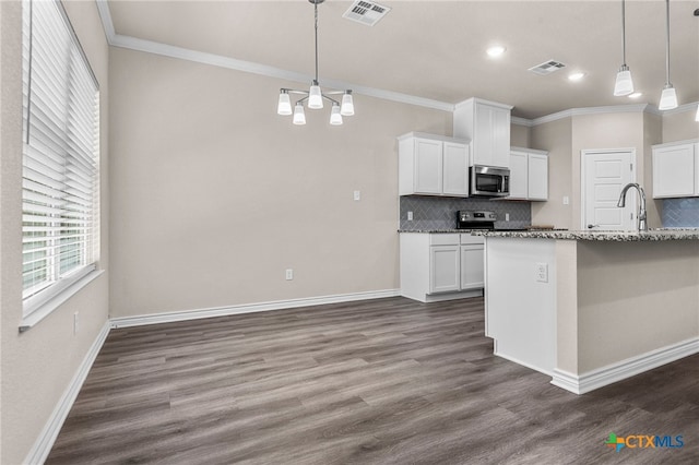 kitchen with white cabinets, decorative backsplash, appliances with stainless steel finishes, decorative light fixtures, and light stone counters