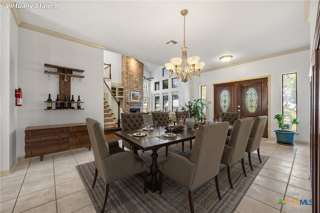 3614 Quail Hollow Rd, Harker Heights, TX 76548 - dining space with light tile patterned floors, a chandelier, stairs, and crown molding
