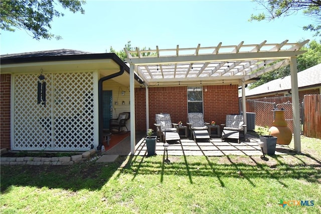 rear view of house featuring a pergola, fence, brick siding, a lawn, and a patio