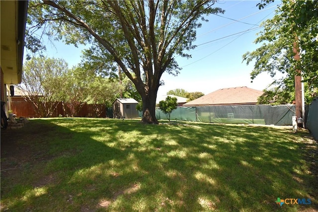 view of yard featuring a fenced backyard, an outbuilding, and a shed