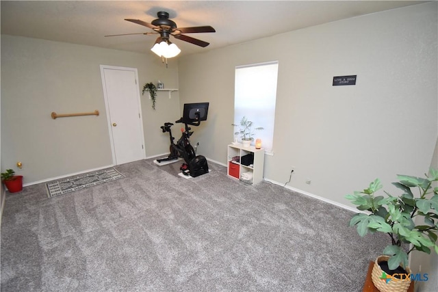 exercise room with baseboards, a ceiling fan, and carpet flooring