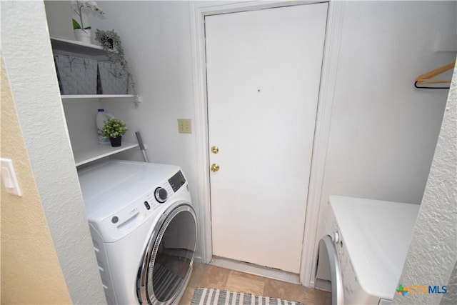 laundry room featuring washer and dryer and laundry area