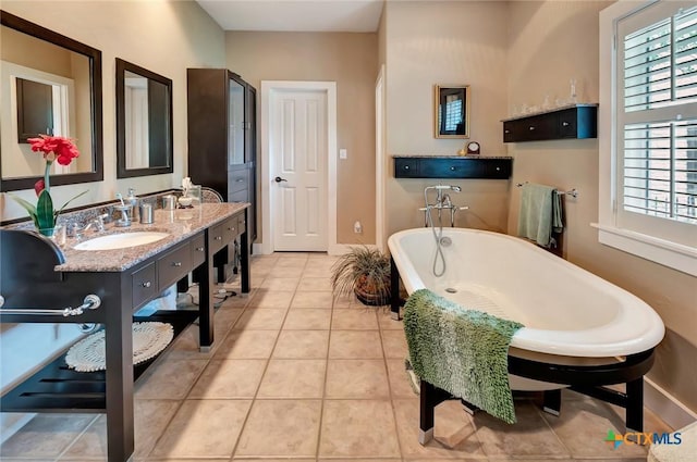 6 Cotswold Ln, Victoria, TX 77904 - bathroom with a freestanding tub, tile patterned flooring, vanity, and baseboards