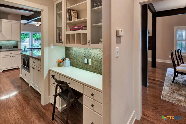 6 Cotswold Ln, Victoria, TX 77904 - kitchen with black microwave, dark wood-type flooring, backsplash, white cabinets, and baseboards