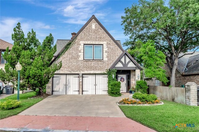 6 Cotswold Ln, Victoria, TX 77904 - english style home featuring brick siding, a garage, and driveway