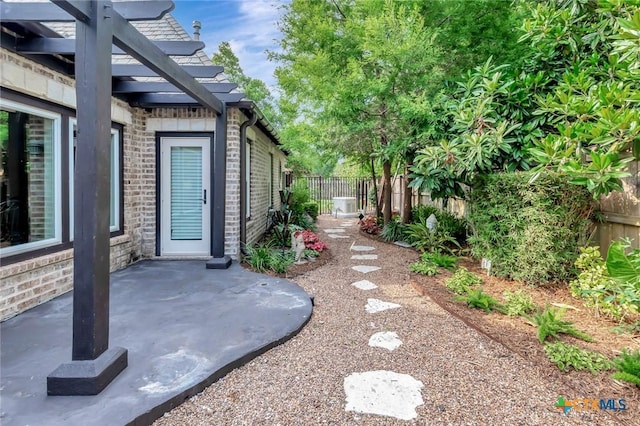 6 Cotswold Ln, Victoria, TX 77904 - fenced backyard featuring a pergola, a patio area, and central AC