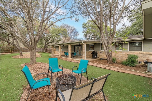 view of patio / terrace with an outdoor fire pit and grilling area