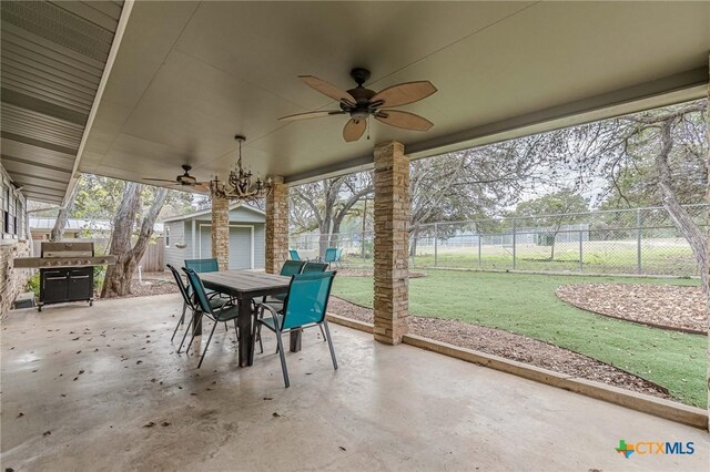 view of patio featuring grilling area, ceiling fan, and an outdoor structure