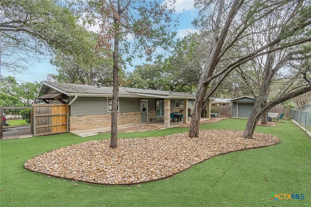 rear view of property featuring an outdoor structure and a patio area