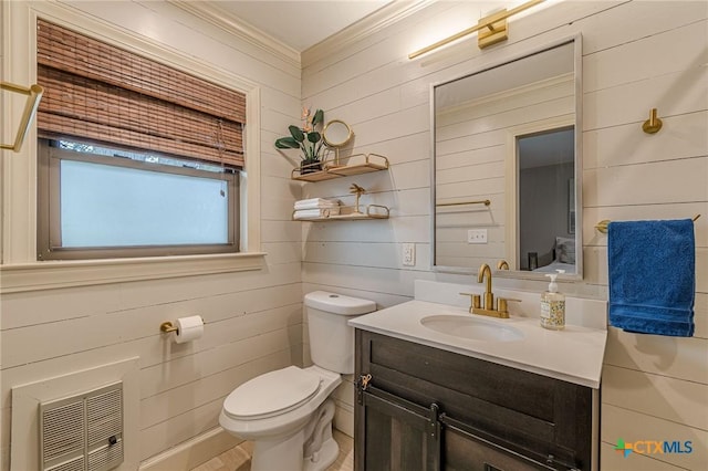 bathroom featuring wooden walls, heating unit, vanity, and toilet