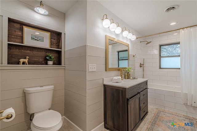 full bathroom with toilet, shower / tub combo with curtain, and vanity