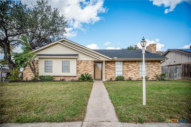 ranch-style house with brick siding, a chimney, a front lawn, and fence
