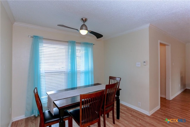 dining area featuring a textured ceiling, ceiling fan, ornamental molding, and hardwood / wood-style flooring