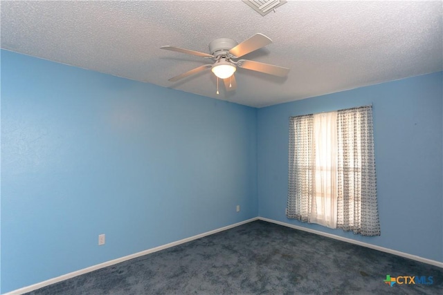 carpeted spare room with ceiling fan and a textured ceiling