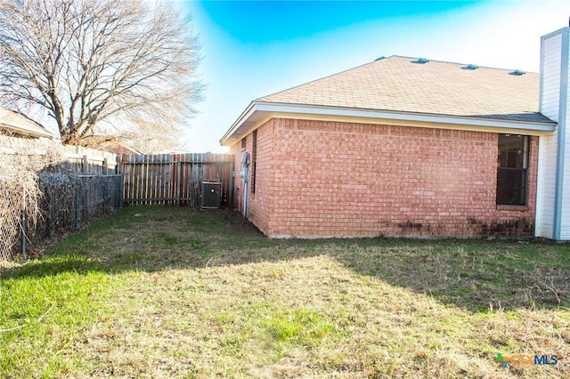 view of home's exterior featuring a yard and central AC