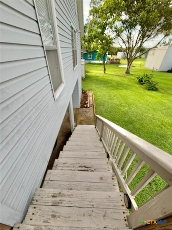 exterior space with a storage shed and a lawn