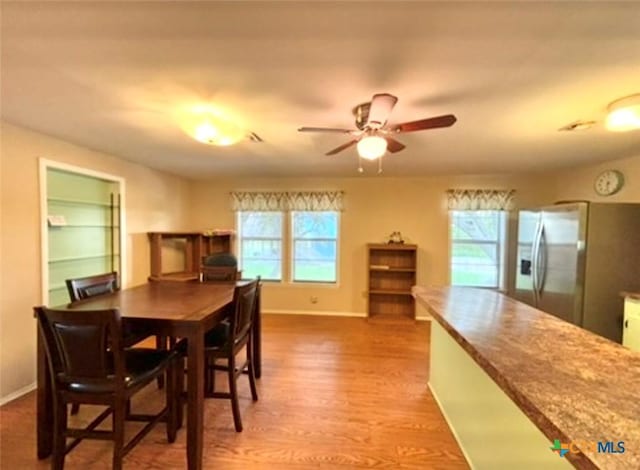 dining space featuring hardwood / wood-style flooring, a wealth of natural light, and ceiling fan