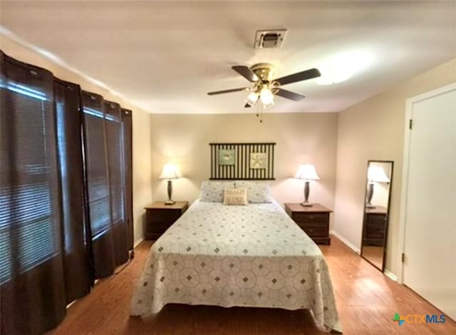 bedroom with ceiling fan and wood-type flooring