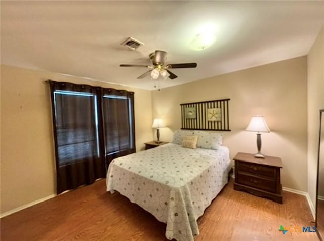 bedroom with ceiling fan and light wood-type flooring