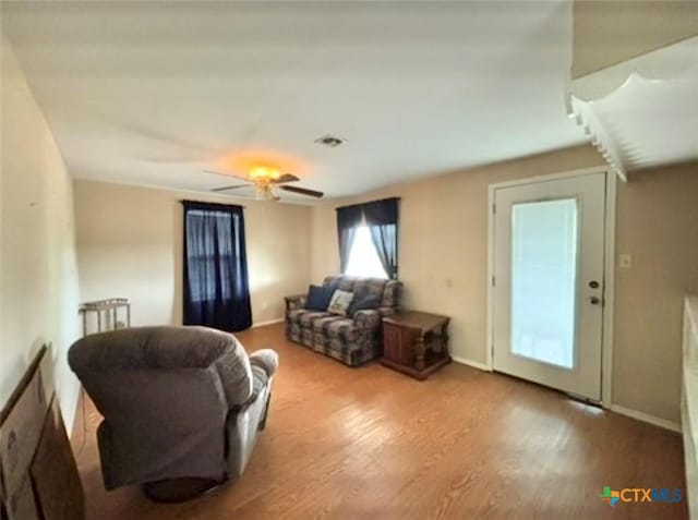 living room featuring hardwood / wood-style flooring and ceiling fan